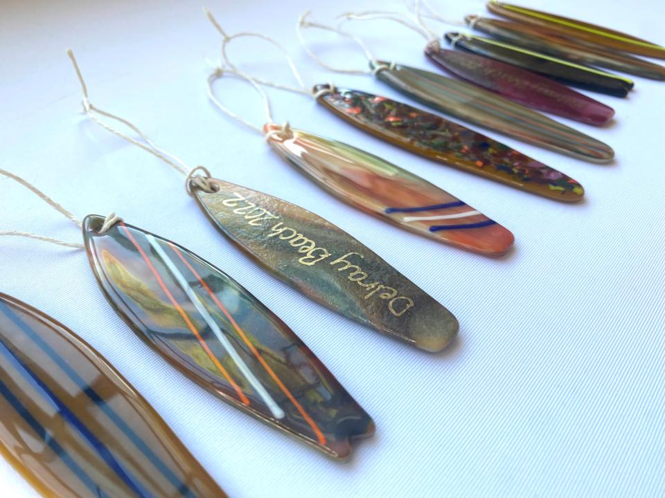 Shoppers spending $200 or more in downtown Delray Beach on Black Friday, Nov. 25 or Small Business Saturday, Nov. 26 can get a free 2022 Delray Beach commemorative kiln-formed glass surfboard ornament in multi colors by local glass artist Robert Schmidt of Schmidt Stained Glass.