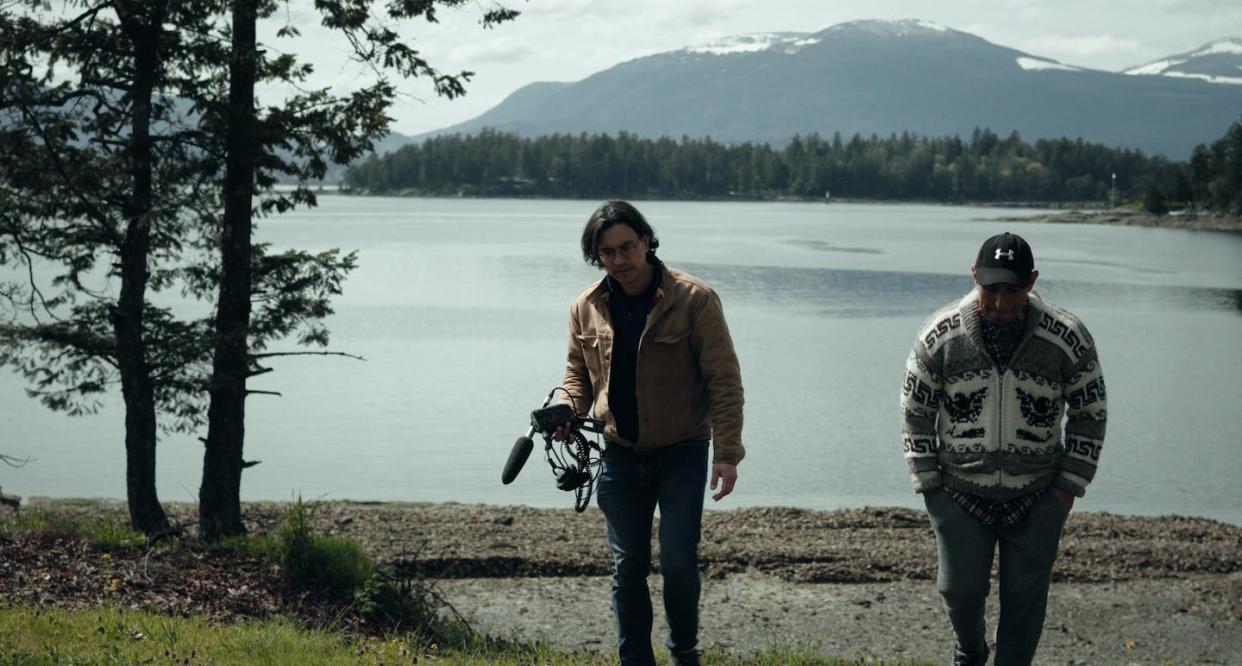 Duncan McCue, left, walks with Rocky James, a podcast guest on CBC's 'Kuper Island.' (Evan Aagaard/CBC Podcasts)