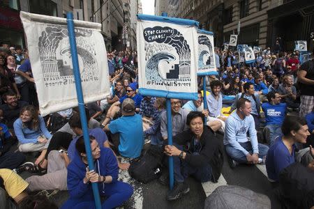 Protesters stage a sit-in during the 'Flood Wall Street' demonstration in Lower Manhattan, New York September 22, 2014. REUTERS/Adrees Latif