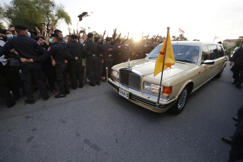 FILE - A vehicle with members of the Thai royal family onboard passes through a road where anti-government protesters gathered outside the Government House in Bangkok, Thailand on Oct. 14, 2020. A Thai court will deliver a verdict on Wednesday, June 28, 2023 in the case of five people accused of impeding the queen’s motorcade during a pro-democracy march in 2020, an offense that if judged egregious could bring a death sentence. (AP Photo/Sakchai Lalit, File)