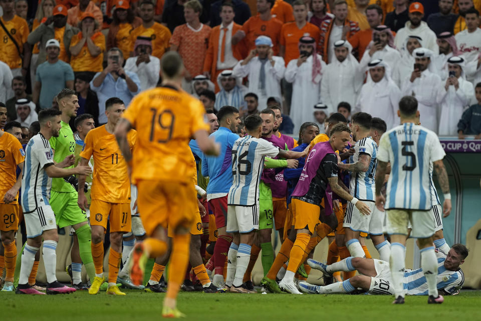 Netherlands and Argentina players argue during the World Cup quarterfinal soccer match between the Netherlands and Argentina, at the Lusail Stadium in Lusail, Qatar, Friday, Dec. 9, 2022. (AP Photo/Jorge Saenz)