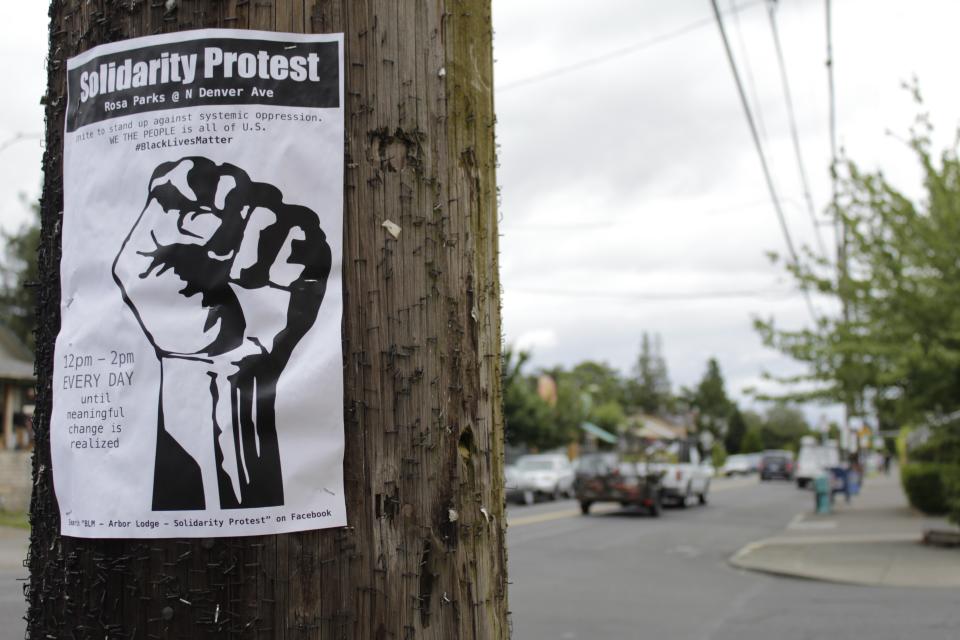 A sign advertising a daily protest in solidarity with Black Lives Matter is affixed to a telephone pole in a historically Black neighborhood in Portland, Ore., on Wednesday, July 1 2020. Thousands of protesters in the liberal and predominantly white city have taken to the streets peacefully every day for more than five weeks to decry police brutality, but recent violence by smaller groups is creating a deep schism in the protest movement and prompting allegations that white protesters are co-opting the moment. (AP Photo/Gillian Flaccus)