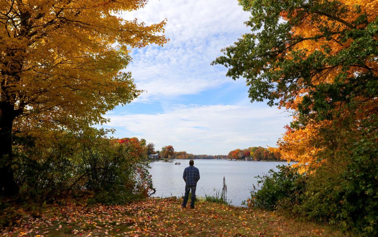James Crouse enjoys the view of Mud Lake from the edge of his 27-acre property in October. The family is selling the lakefront property.