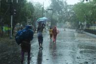 Residents walk along a street to a shelter ahead of the expected landfall of cyclone Amphan in Digha, West Bengal, on May 20, 2020. - India and Bangladesh began evacuating more than two million people on May 18 as a cyclone barrelled towards their coasts, with officials racing to ready extra shelters amid fears of coronavirus contagion in cramped refuges. (Photo by Dibyangshu SARKAR / AFP) (Photo by DIBYANGSHU SARKAR/AFP via Getty Images)