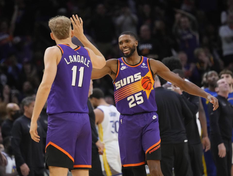 Phoenix Suns center Jock Landale (11) and forward Mikal Bridges (25) slap hands after a play against the Golden State Warriors during the third quarter at Footprint Center in Phoenix on Oct. 25, 2022.