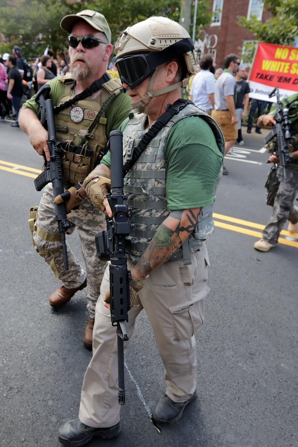 Two members of a private militia patrol the Charlottesville rally where white nationalists and counter-protesters clashed on Aug. 12, 2017.