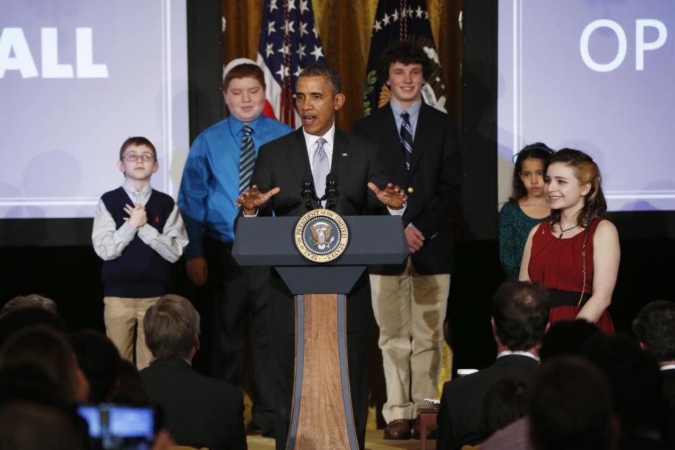 President Barack Obama speaks at the first White House Student Film Festival, Friday, Feb. 28, 2014, in the East Room at the White House in Washington. Student filmmakers pictured, Miles Pilchik, left, and Gabrielle Nafie, second right, second graders, SciTech in New York, Kids; Kyle Weintraub, second left, seventh grade, from David Posnack Jewish Day School in Davie, Fla.; and Shelly Ortiz, high school senior at Metropolitan Arts Institute, from Phoenix, Ariz. (AP Photo/Charles Dharapak)