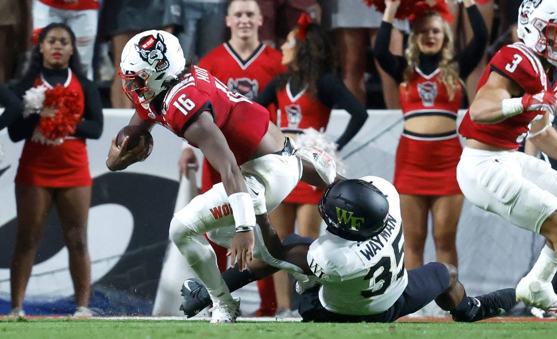 N.C. State quarterback MJ Morris (16) is sacked by Wake Forest defensive lineman Kendron Wayman (35) during the first half of N.C. State’s game against Wake Forest at Carter-Finley Stadium in Raleigh, N.C., Saturday, Nov. 5, 2022.