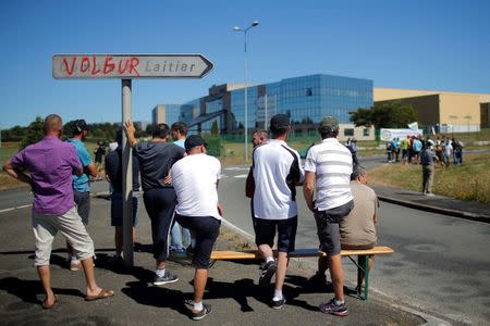 French dairy farmers from the FNSEA union gather as they block the round-about access to the Lactalis plant, with a sign that reads "Thief", as they protest against the price of milk in Laval, France, August 23, 2016. REUTERS/Stephane Mahe