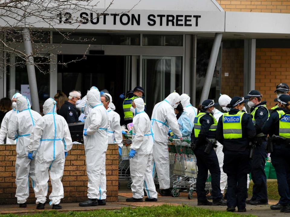 Firefighters prepare to distribute food throughout a Melbourne public housing tower, locked down in response to an outbreak of coronavirus: REUTERS