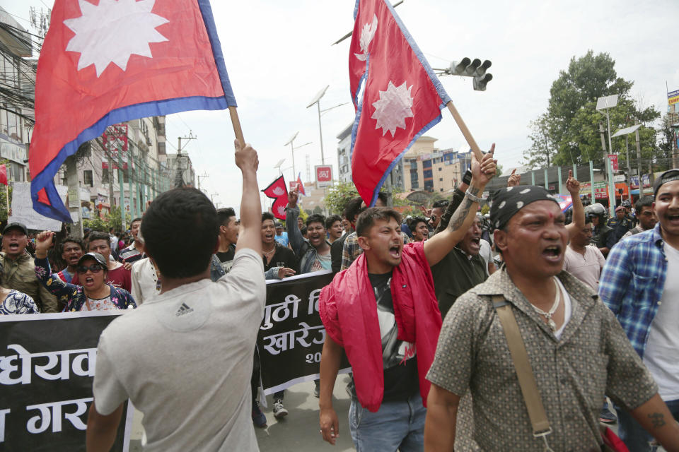 Nepalese Newar community people shout slogans during a protest against government in Kathmandu, Nepal, Wednesday, June 19, 2019. Thousands of people protested in the Nepalese capital to protest a Bill that would give government control over community and religious trusts. Protesters demanded the government scrap the proposed Bill to protect these trusts that hold religious ceremonies and festivals. (AP Photo/Niranjan Shrestha)