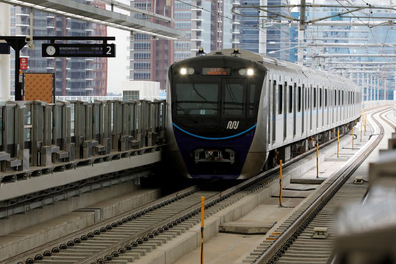 FILE PHOTO: A Mass Rapid Transit (MRT) train arrives at a station during its full trial run in Jakarta