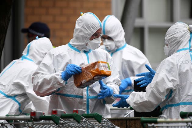 Firefighters dressed in personal protective equipment prepare to distribute food throughout a public housing tower, locked down in response to an outbreak of the coronavirus disease (COVID-19), in Melbourne, Australia, July 7, 2020. 