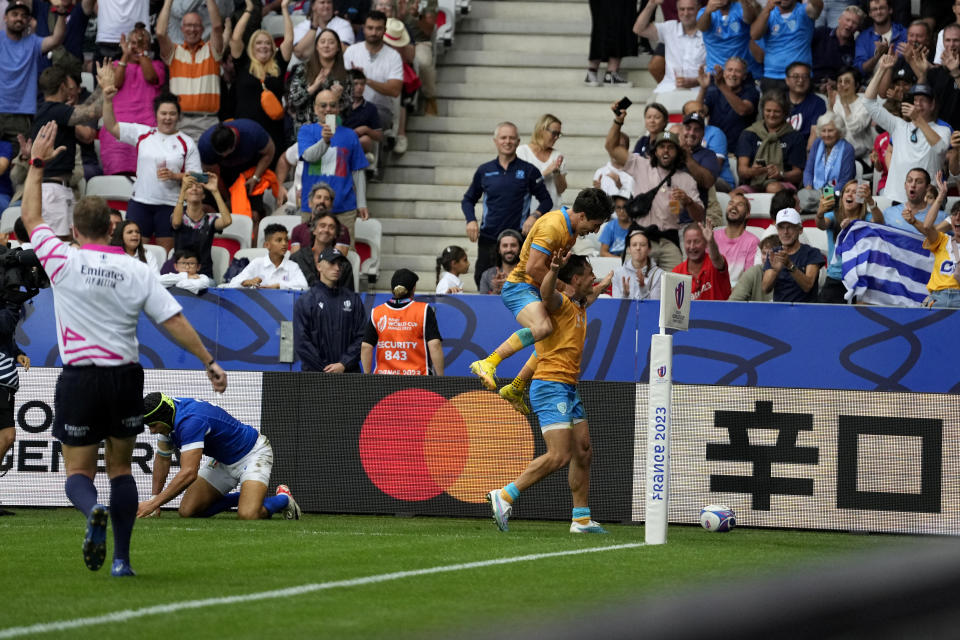 Uruguay's Nicolas Freitas celebrates with teammate Santiago Arata after scoring a try during the Rugby World Cup Pool A match between Italy and Uruguay at the Stade de Nice, in Nice, Wednesday, Sept. 20, 2023. (AP Photo/Pavel Golovkin)