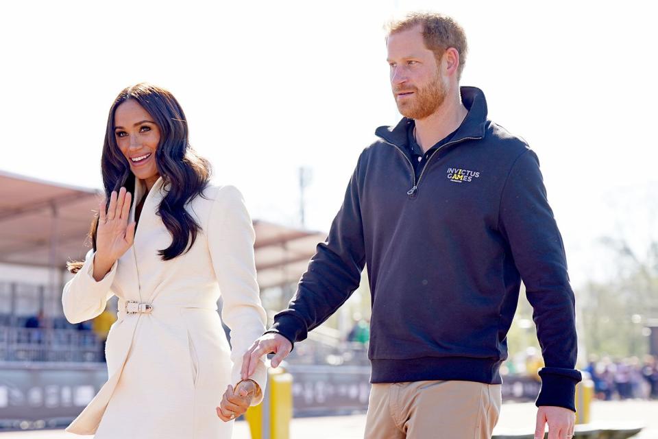 <p>Aaron Chown/PA/Getty</p> Meghan Markle and Prince Harry at the Invictus Games in April 2022