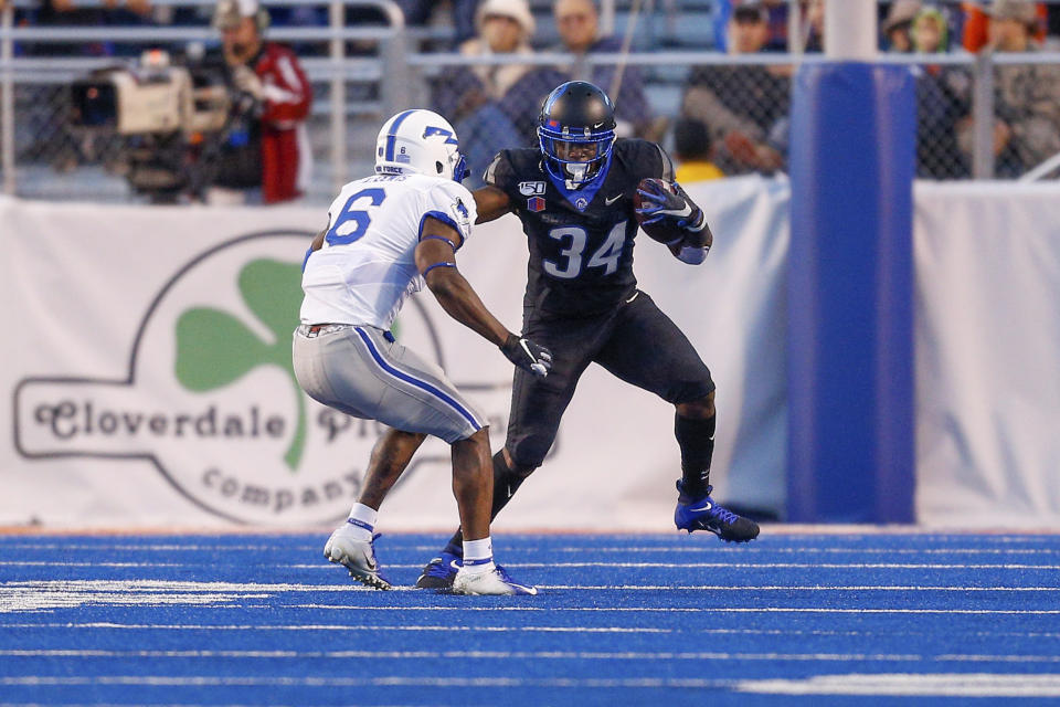 Boise State running back Robert Mahone (34) runs at Air Force defensive back Zane Lewis (6) with the ball in the first half of an NCAA college football game, Friday, Sept. 20, 2019, in Boise, Idaho. (AP Photo/Steve Conner)