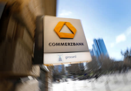 FILE PHOTO: A sign for an ATM of Commerzbank is seen next to the headquarters of Deutsche Bank (R) in Frankfurt, Germany, March 19, 2019. REUTERS/Kai Pfaffenbach/File Photo