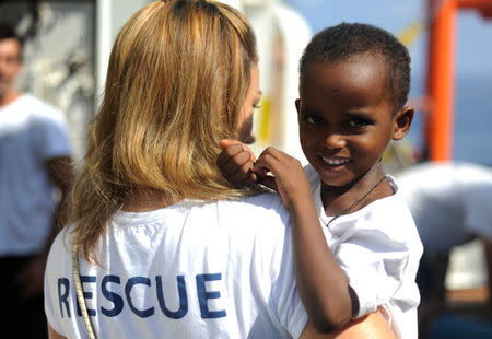 A migrant smiles on board the MV Aquarius rescue ship, run by SOS Mediterranee organisation and Doctors Without Borders, during a search and rescue (SAR) operation in the Mediterranean Sea, off the Libyan Coast, August 12, 2018. Picture taken August 12, 2018. REUTERS/Guglielmo Mangiapane