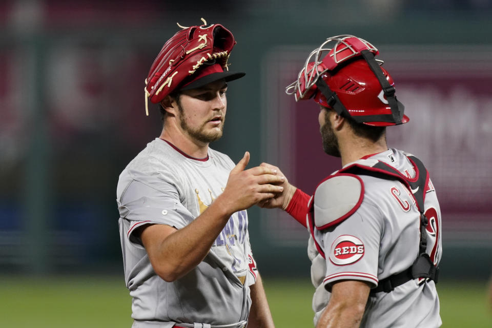 Cincinnati Reds starting pitcher Trevor Bauer and catcher Curt Casali celebrate after game two of a baseball doubleheader against the Kansas City Royals Wednesday, Aug. 19, 2020, in Kansas City, Mo. (AP Photo/Charlie Riedel)