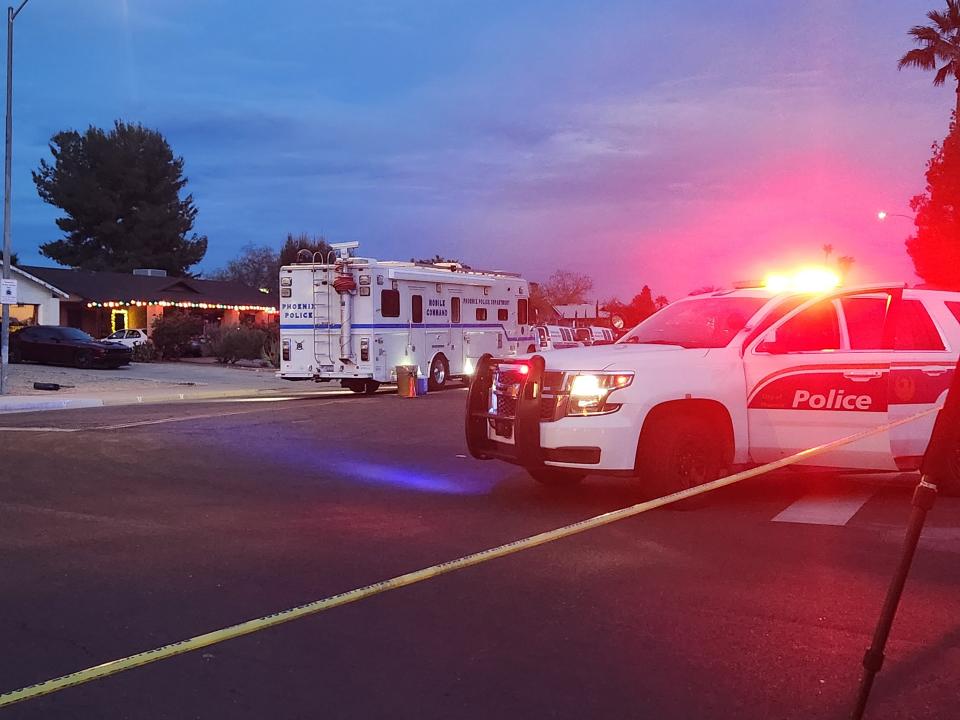 Phoenix police surround a residence at 23rd Avenue and Utopia Road, belonging to a suspect who police believe killed his wife, son, and another man the afternoon of Dec. 18, 2023.