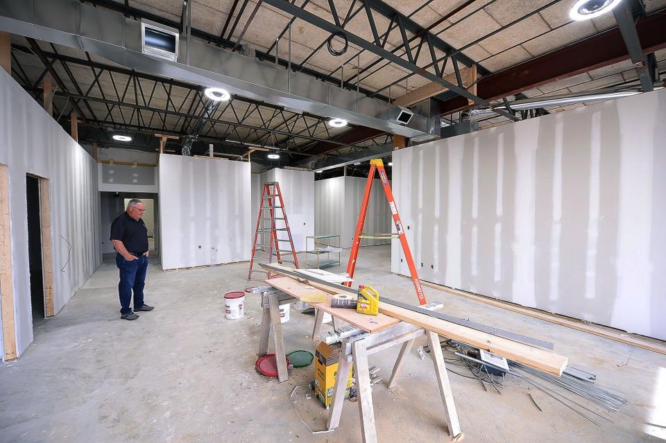 Kevin Simmers, founder of Brooke's House, looks over work inside a recovery center that is under construction at the South End Shopping Center. The 4,150 squre-foot facility will provide walk-in assessments for those suffering from addiction.