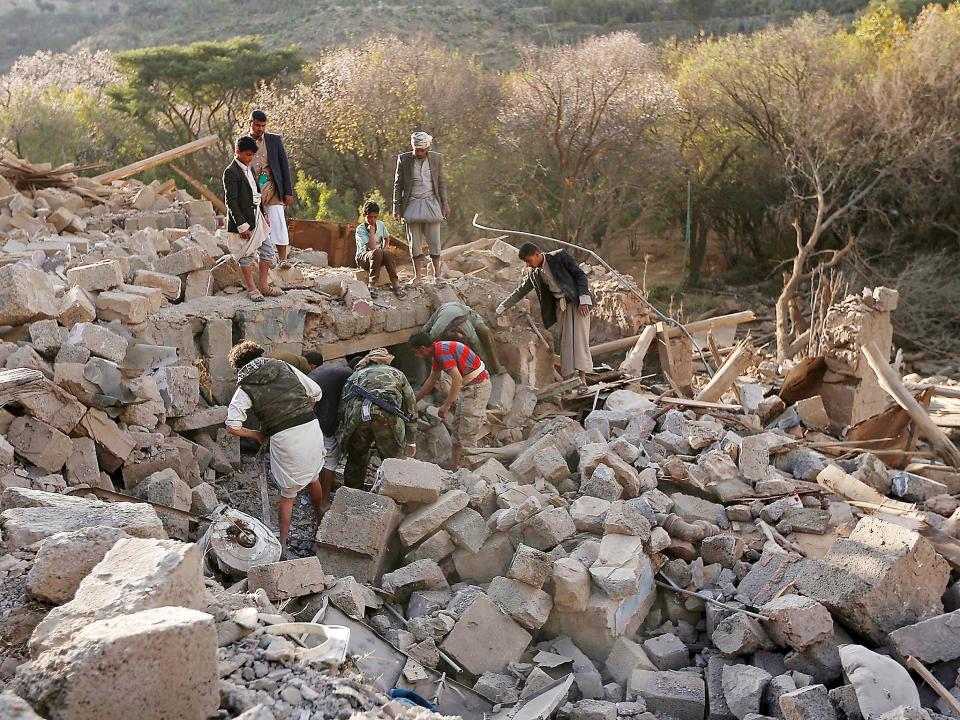 Yemenis inspect damaged houses following reported Saudi-led coalition air strikes on the outskirts of the Yemeni capital Sana’a (Getty)