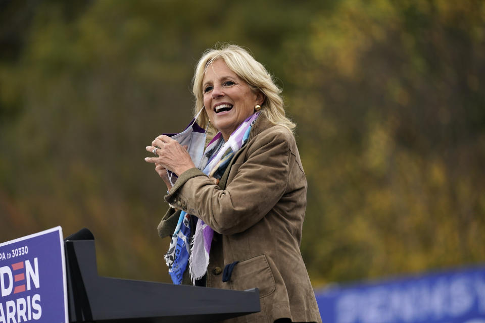 FILE - Jill Biden, the wife of Democratic presidential candidate former Vice President Joe Biden, removes her face mask at a campaign stop at Bucks County Community College, Saturday, Oct. 24, 2020, in Bristol, Pa. “Jill: A Biography of the First Lady,” by Associated Press journalists Julie Pace and Darlene Superville, details the life of Jill Biden. Superville covers the White House for the AP; Pace, a former White House correspondent and Washington bureau chief, is now AP’s executive editor. (AP Photo/Andrew Harnik, File)