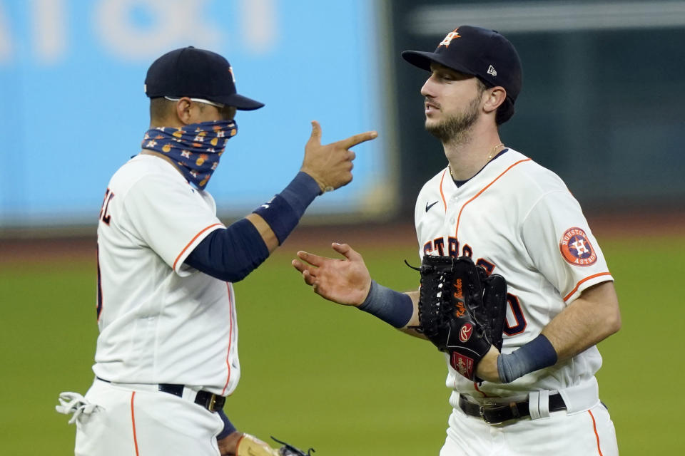 Houston Astros' Kyle Tucker, right, celebrates with Yuli Gurriel after a baseball game against the Texas Rangers Thursday, Sept. 17, 2020, in Houston. The Astros won 2-1. (AP Photo/David J. Phillip)