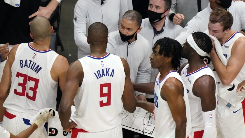 Los Angeles Clippers head coach Tyronn Lue, center, talks to his players during a timeout in the second half of an NBA basketball game against the Atlanta Hawks Tuesday, Jan. 2 6, 2021, in Atlanta. (AP Photo/John Bazemore)