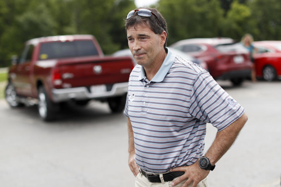 Republican Troy Balderson, a candidate for Ohio's 12th District, stands in the parking lot of a voting precinct at Genoa Baptist Church, Tuesday, Aug. 7, 2018, in Westerville, Ohio. Balderson, is fighting off a strong challenge from Democrat Danny O'Connor, 31-year-old county official, in a congressional district held by the Republican Party for more than three decades. (AP Photo/John Minchillo)