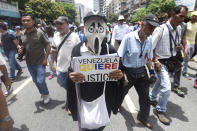 <p>Opposition activists march in Caracas on May 22, 2017.<br> Doctors rallied in Venezuela on Monday in the latest street protests against the government of President Nicolas Maduro, as a young man lay in hospital after being set on fire by an angry crowd. (Photo: Juan Barreto/AFP/Getty Images) </p>