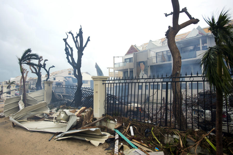 <p>Smoke rises from a fire near debris and damaged buildings in Marigot, near the Bay of Nettle, on the French Collectivity of Saint Martin, after the passage of Hurricane Irma, on Sept. 6, 2017. (Photo: Lionel Chamoiseau/AFP/Getty Images) </p>