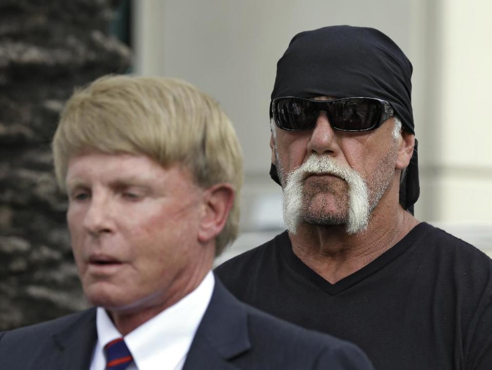 Reality TV star and former pro wrestler Hulk Hogan, whose real name is Terry Bollea, looks on as his attorney David Houston speaks during a news conference Monday, Oct. 15, 2012 at the United States Courthouse in Tampa, Fla. Hogan says he was secretly taped six years ago having sex with the ex-wife of DJ Bubba "The Love Sponge" Clem. Portions of the video of Hogan and Heather Clem were posted on the online gossip site Gawker. (AP Photo/Chris O'Meara)