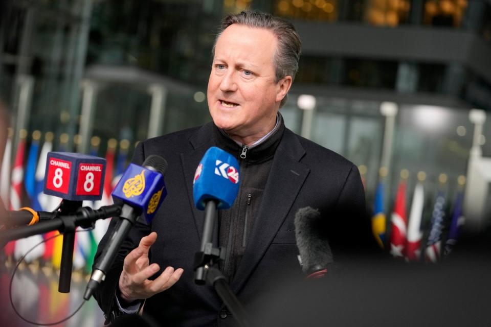 David Cameron has urged allies to spend more on defence during a meeting of Nato foreign ministers in Brussels (AP)