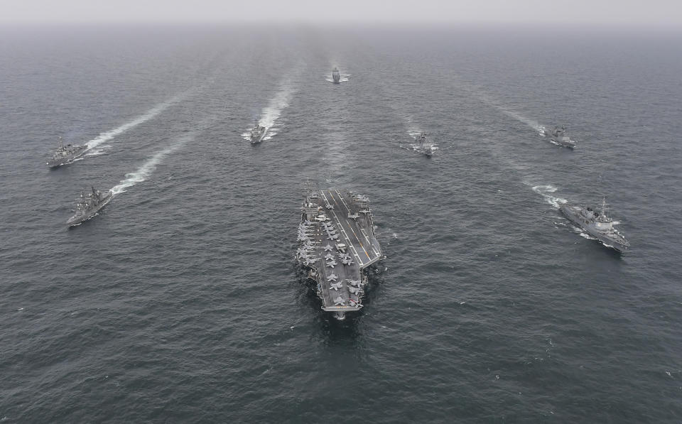 FILE - In this photo provided by the South Korea Defense Ministry, South Korean Navy's destroyer Yulgok Yi I, front row right, U.S. Navy's aircraft carrier USS Nimitz, center, Japan Maritime Self-Defense Force's Umigiri, front row left, sail in formation during a joint naval exercise in international waters off South Korea's southern island of Jeju on April 4, 2023. (South Korea Defense Ministry via AP, File)