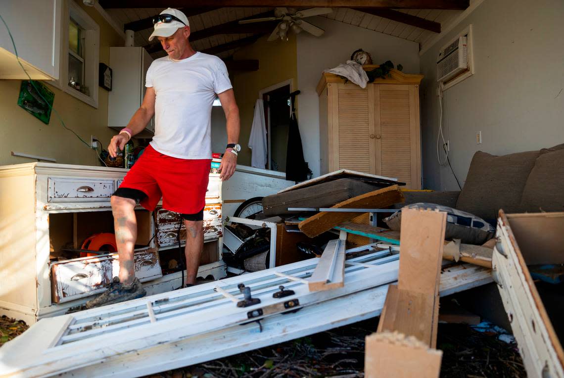 Jesse Tincher surveys his home on Thursday, Sept. 29, 2022, in Matlacha, Florida. Hurricane Ian made landfall on the coast of Southwest Florida as a Category 4 storm Wednesday afternoon, leaving areas affected with flooded streets, downed trees and scattered debris.