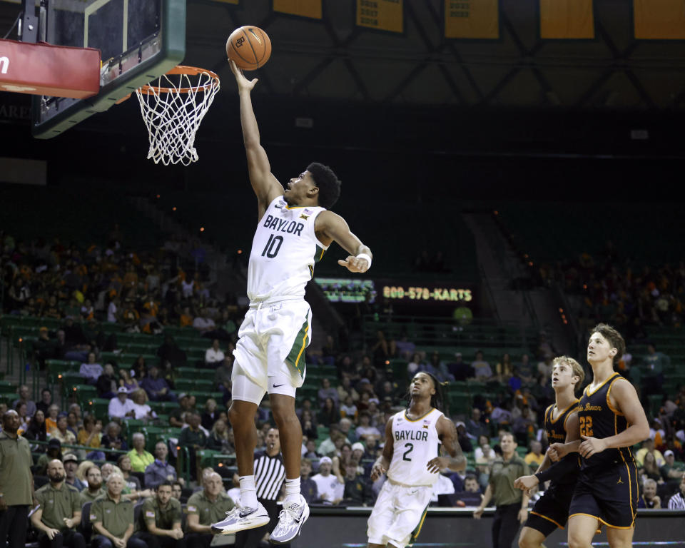 Baylor guard RayJ Dennis scores past the John Brown defense in the second half of an NCAA college basketball game, Thursday, Nov. 9, 2023, in Waco, Texas. (AP Photo/Rod Aydelotte)