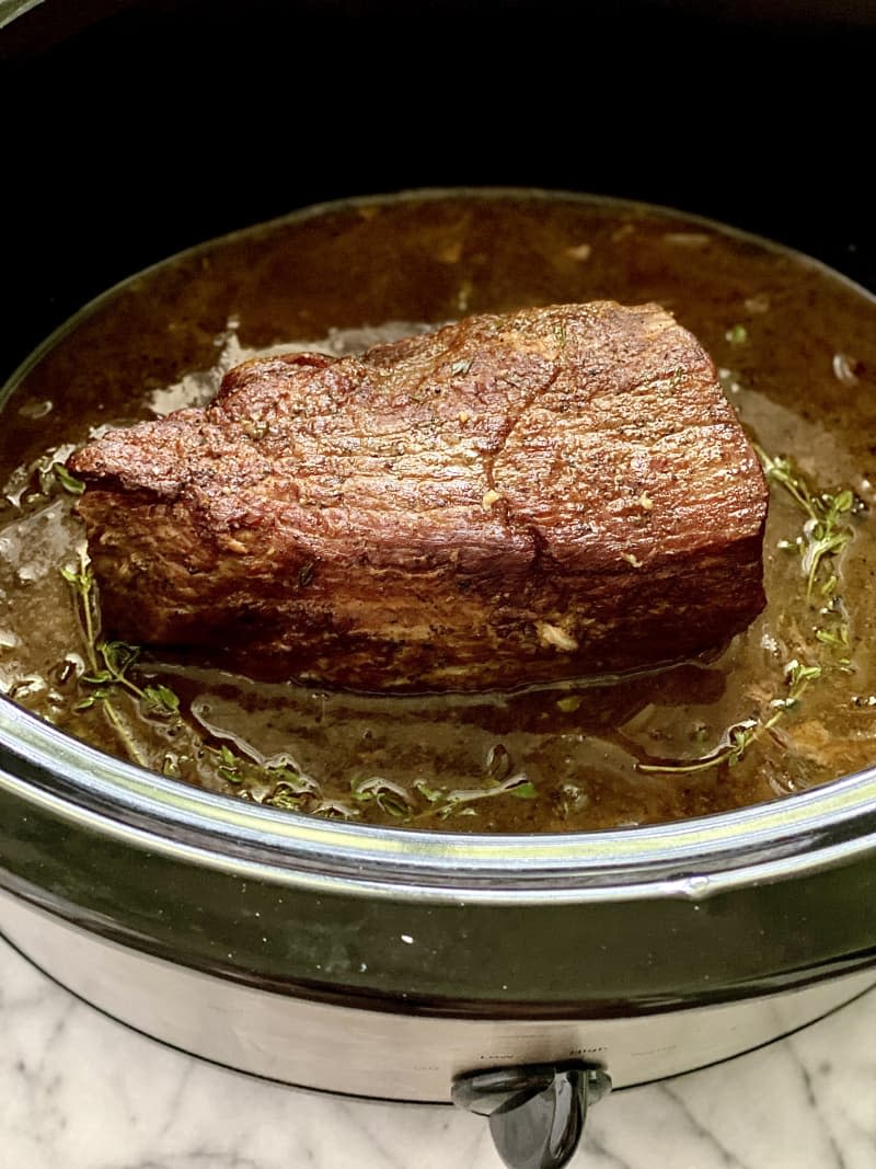 Slow cooker roast beef in the slow cooker.