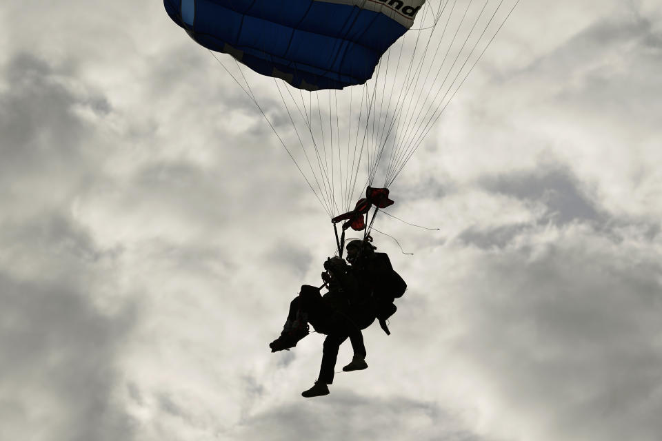 Texas Gov. Greg Abbott skydives in tandem Monday, Nov. 27, 2023, in Fentress, Texas. Abbott was invited to jump by 106-year-old World War II veteran Al Blaschke. (AP Photo/Eric Gay)