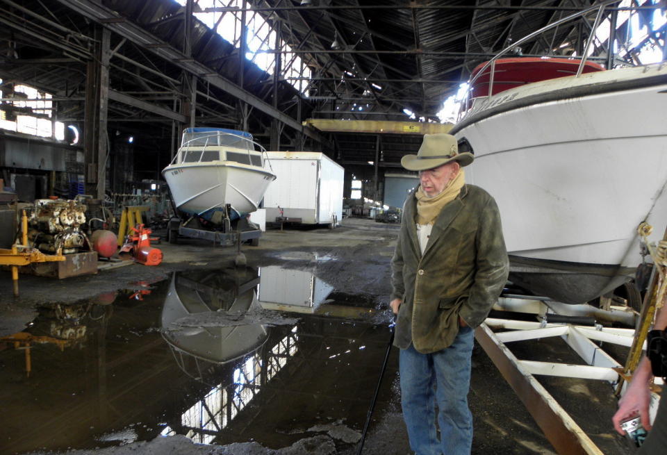 R.C. "Heck" Heckert inspects fire and water damage at one of his buildings adjacent to the site of the IEI fire. Heckert, who runs a taxi service and operates riverboats, says he lost three buildings to the fire, but doesn't blame IEI owners. (Photo: Karen Schaefer/For HuffPost)