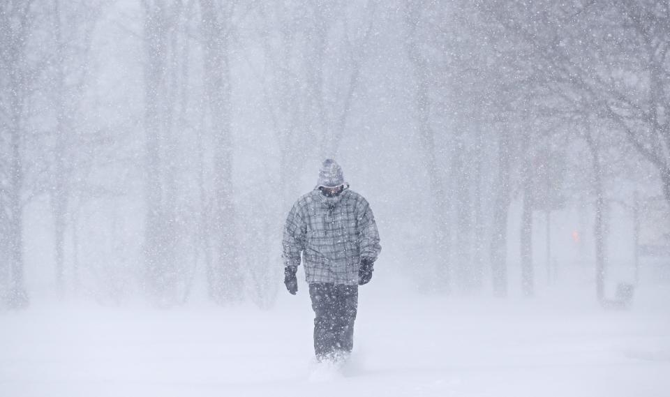 A man walks on the Plains of Abraham during a snowstorm in Quebec City