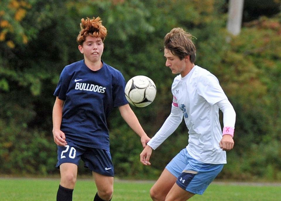 Rockland's Jacob Asplund, left, and East Bridgewater's Zachary Higgins, right, go after a loose ball during boys soccer at Rockland High School, Monday, Oct. 3, 2022.