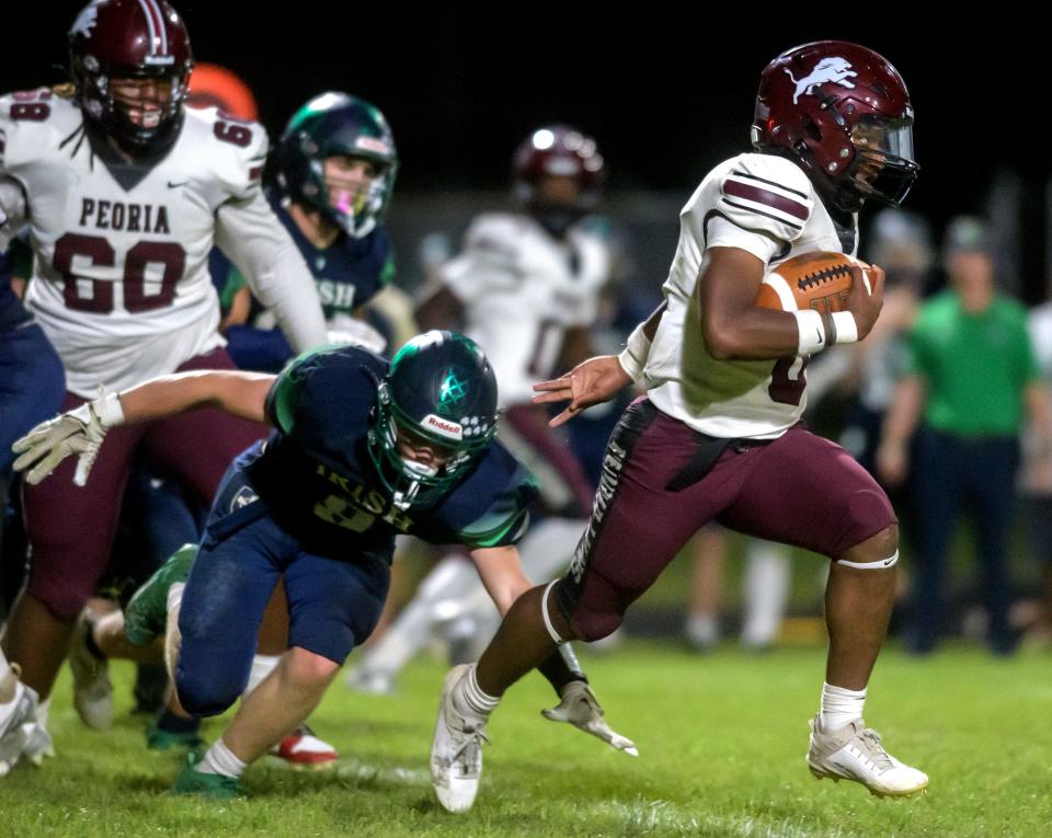 Peoria High running back Detaurion Pollard gets past the Peoria Notre Dame defense in the second half of their Week 2 football game Friday, Sept. 6, 2024 at Richwoods Stadium. The Lions defeated the Irish 46-40.