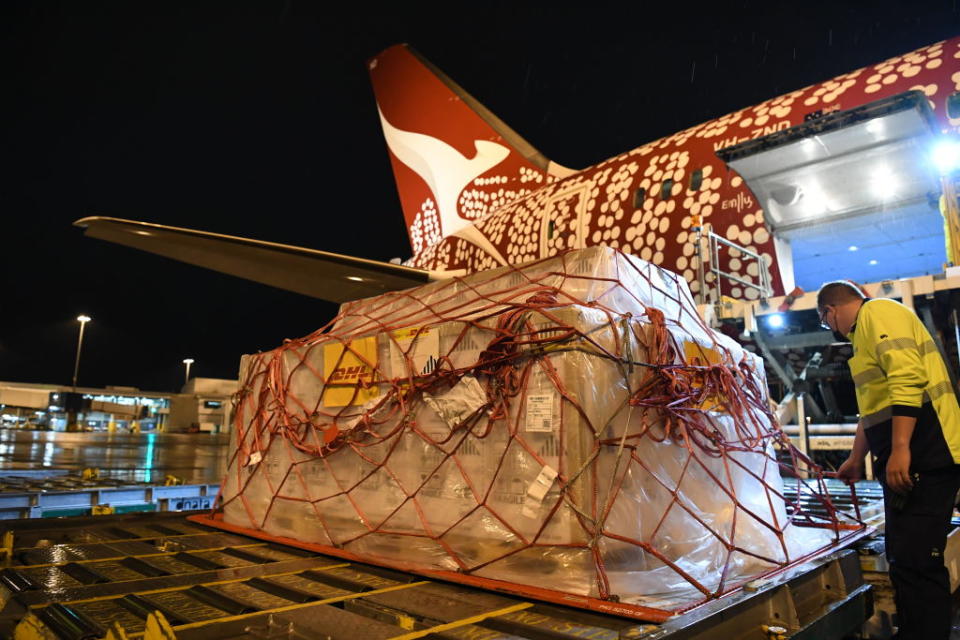 A pallet of Pfizer vaccines is unloaded after landing on Qantas flight QF10 from London at Kingsford Smith International Airport in Sydney, Australia. 