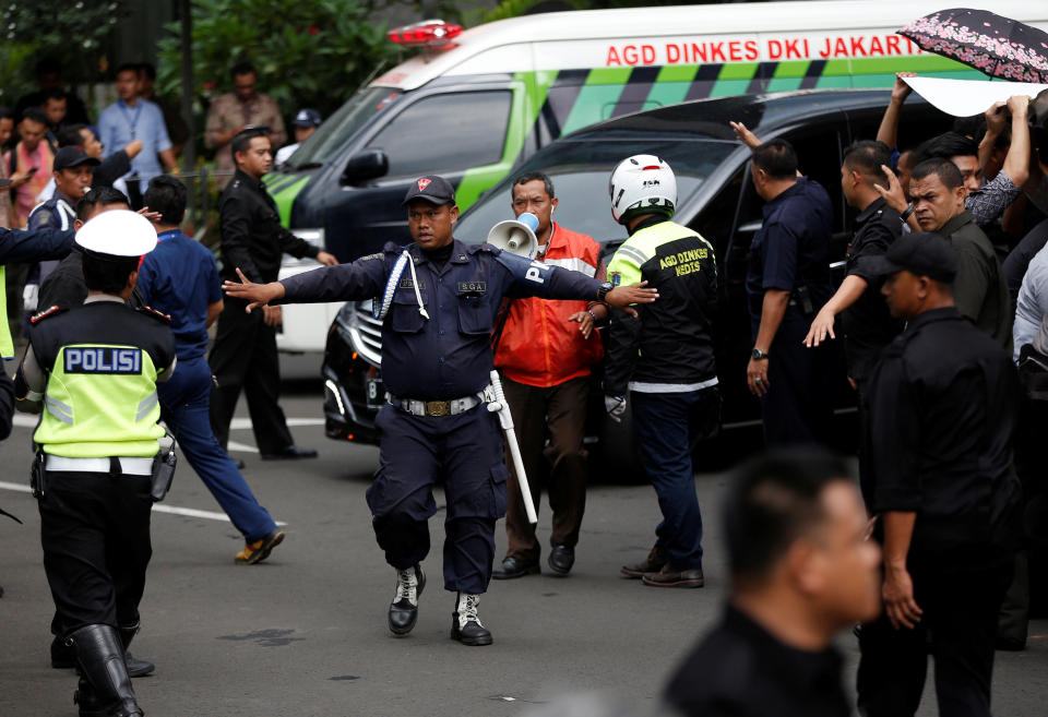 Security makes way for a vehicle carrying an injured person