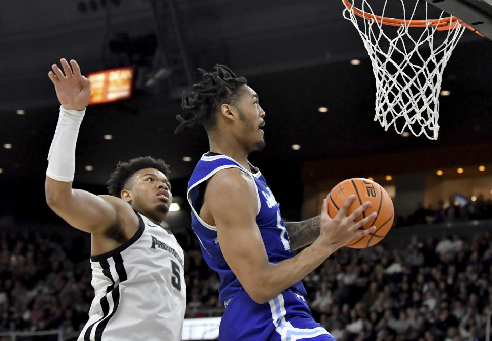 Providence forward Ed Croswell (5) moves in to block a shot by Seton Hall guard Dre Davis (14) during the first half of an NCAA college basketball game Saturday, March 4, 2023, in Providence, R.I. (AP Photo/Mark Stockwell)