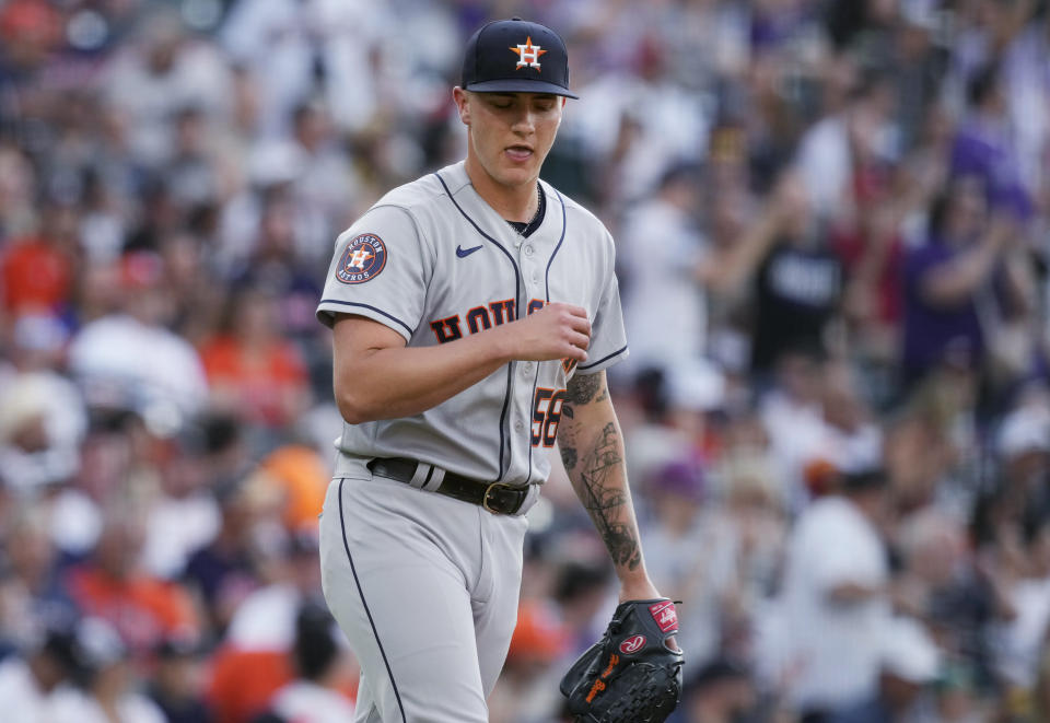 Houston Astros starting pitcher Hunter Brown looks down after giving up a two-run home run to Colorado Rockies' Kris Bryant during the first inning of a baseball game Tuesday, July 18, 2023, in Denver. (AP Photo/David Zalubowski)