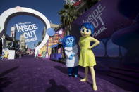 "Joy" and "Sadness", characters of the animation film "Inside Out", pose at its premiere at El Capitan theatre in Hollywood, California June 8, 2015. The movie opens in the U.S. on June 19. REUTERS/Mario Anzuoni