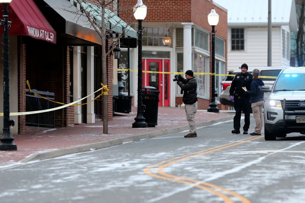 Investigators are seen outside Melody Hookah Lounge in downtown Blacksburg on Saturday following the shooting the night before (AP)