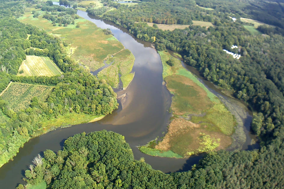 In this Sept 13, 2018 photo provided by the Environmental Protection Agency shows an aerial view of the Kalamazoo River immediately upstream from the Trowbridge Dam near Allegan, Mich., in southwestern Michigan.The first step is to stabilize the dam structure so that it won't collapse while a contractor dredges PCB-laced sediments from this 2.4-mile river section upstream, which is expected to take three years, said Paul Ruesch, the EPA's on-site coordinator. (Paul Ruesch/Environmental Protection Agency via AP)